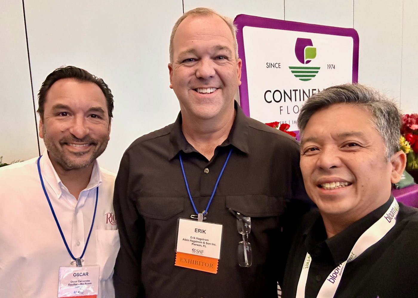 Renato Cruz Sogueco with flower growers on a trade show floor